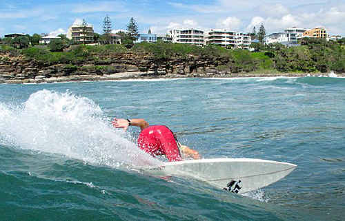A surfer picks up a ride off Moffat Beach.